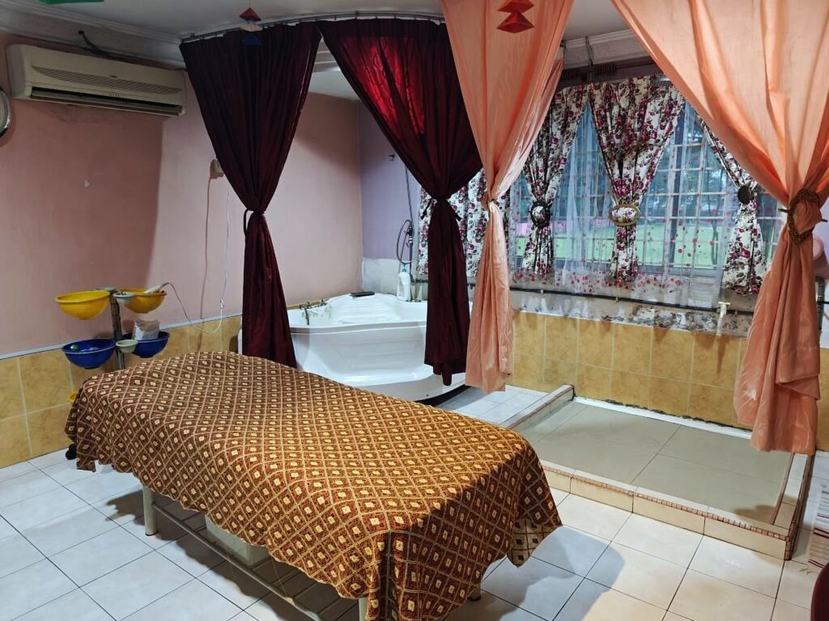 Bilik rawatan tertutup di Al-Hikmah Kampung Pandan, dengan katil rawatan, tab mandi dan langsir privasi